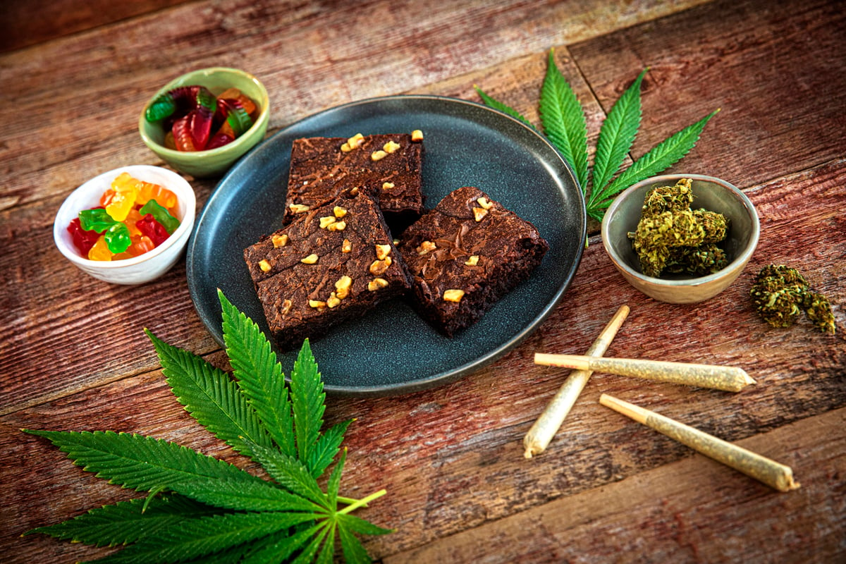 Cannabis edibles on a table: brownies, joints, gummies
