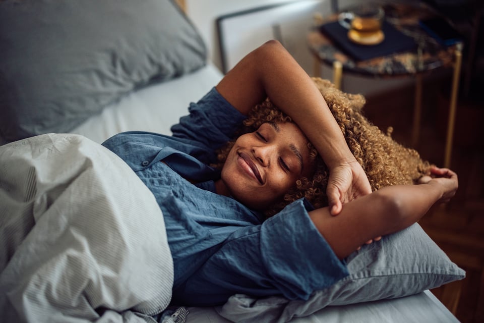 Smiling woman de-stress before bedtime by using cannabis